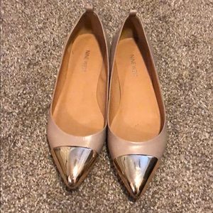 Nine West nude flats with gold mirror tips.